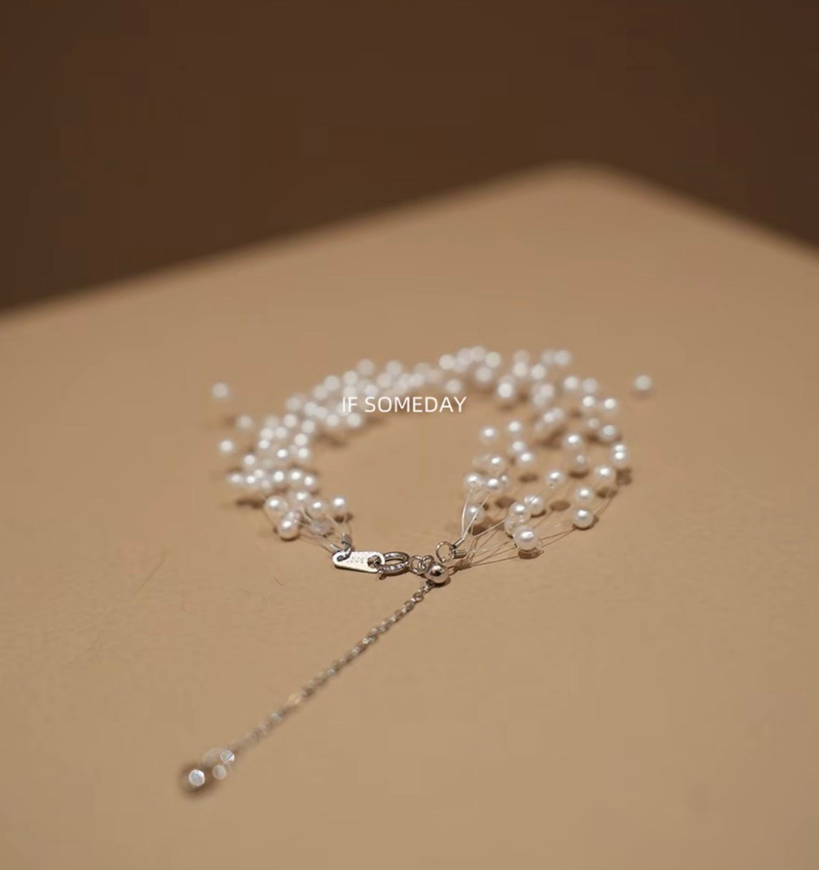 Handmade natural pearl bracelet with a starry design, made with fishing line and silver chain.