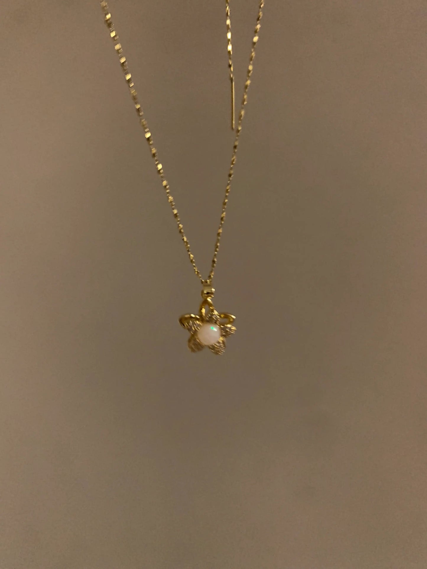 Gold flower necklace with opal center, minimalist design for everyday wear