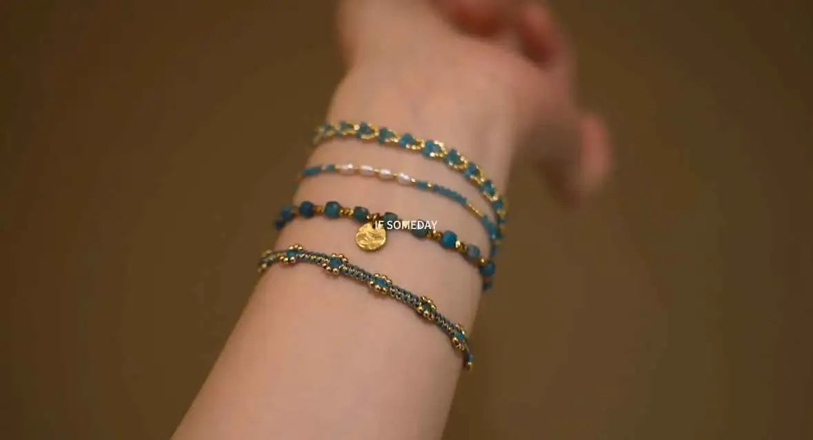 Layered blue beaded bracelets with gold accents, minimalist stackable jewelry for everyday wear