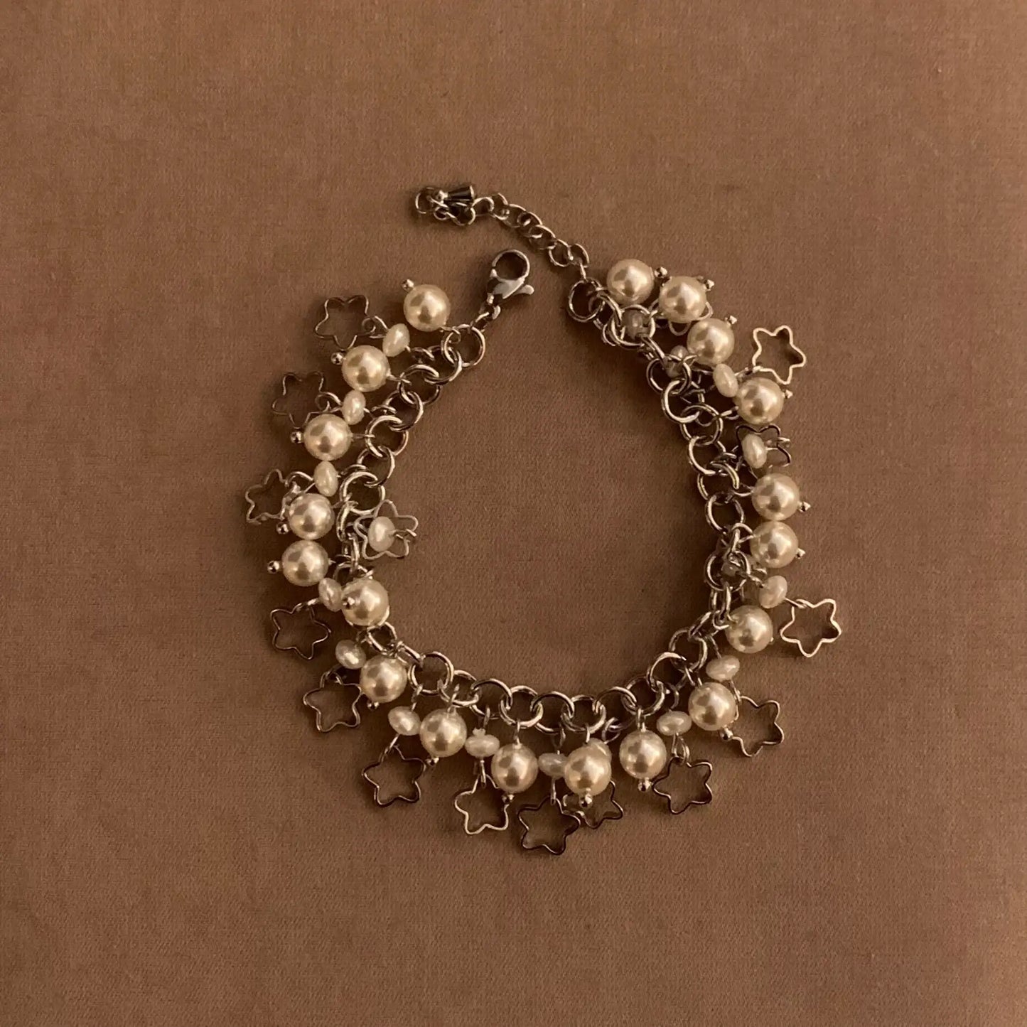 Elegant pearl and star charm bracelet with silver chain, minimalist jewelry design