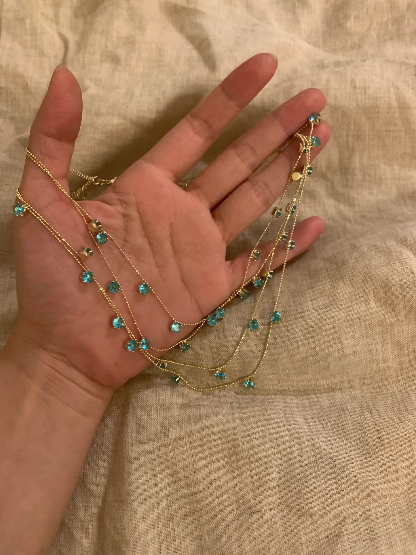 Gold necklace with blue gemstones, handcrafted minimalist jewelry