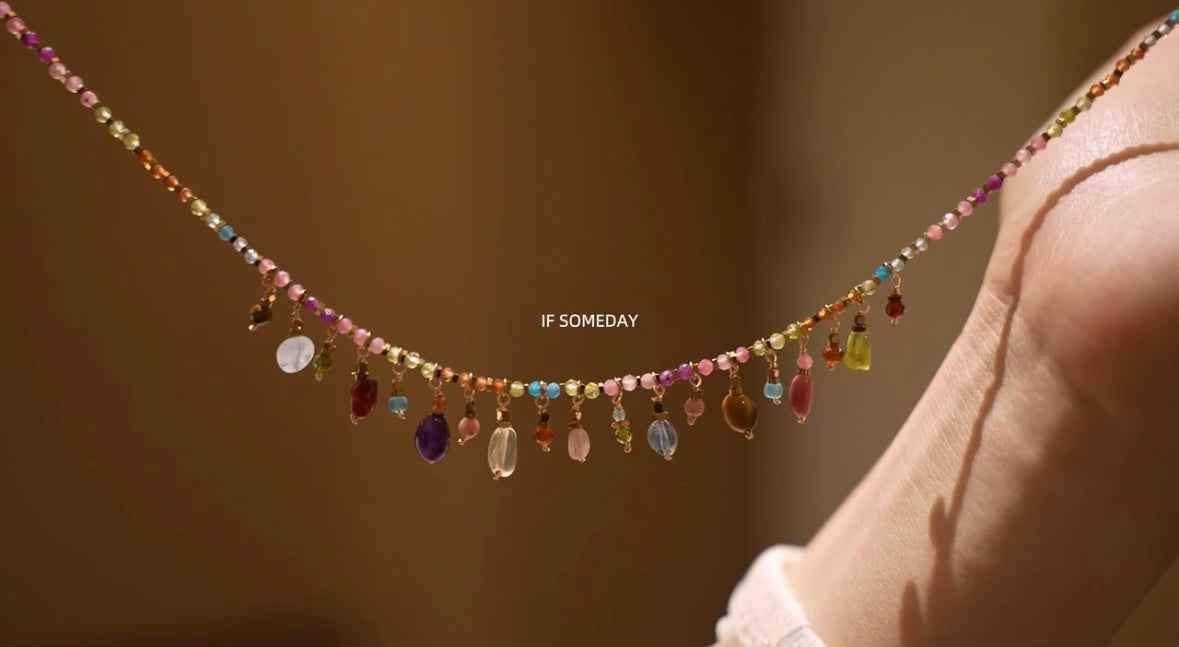 Colorful beaded necklace with dangling charms, minimalist design, ethical materials