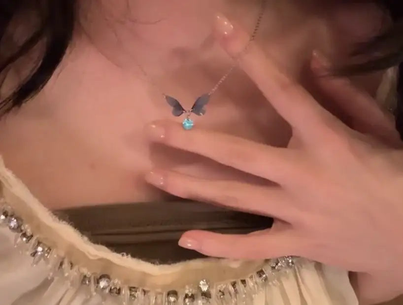 Delicate butterfly necklace with blue gem, minimalist jewelry for everyday elegance