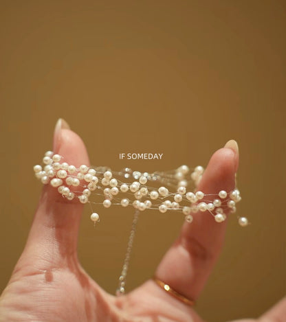 Handmade natural pearl bracelet with a starry design, made with fishing line and silver chain.