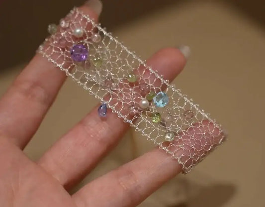 Delicate wire mesh bracelet with colorful gemstones and pearls, minimalist jewelry design