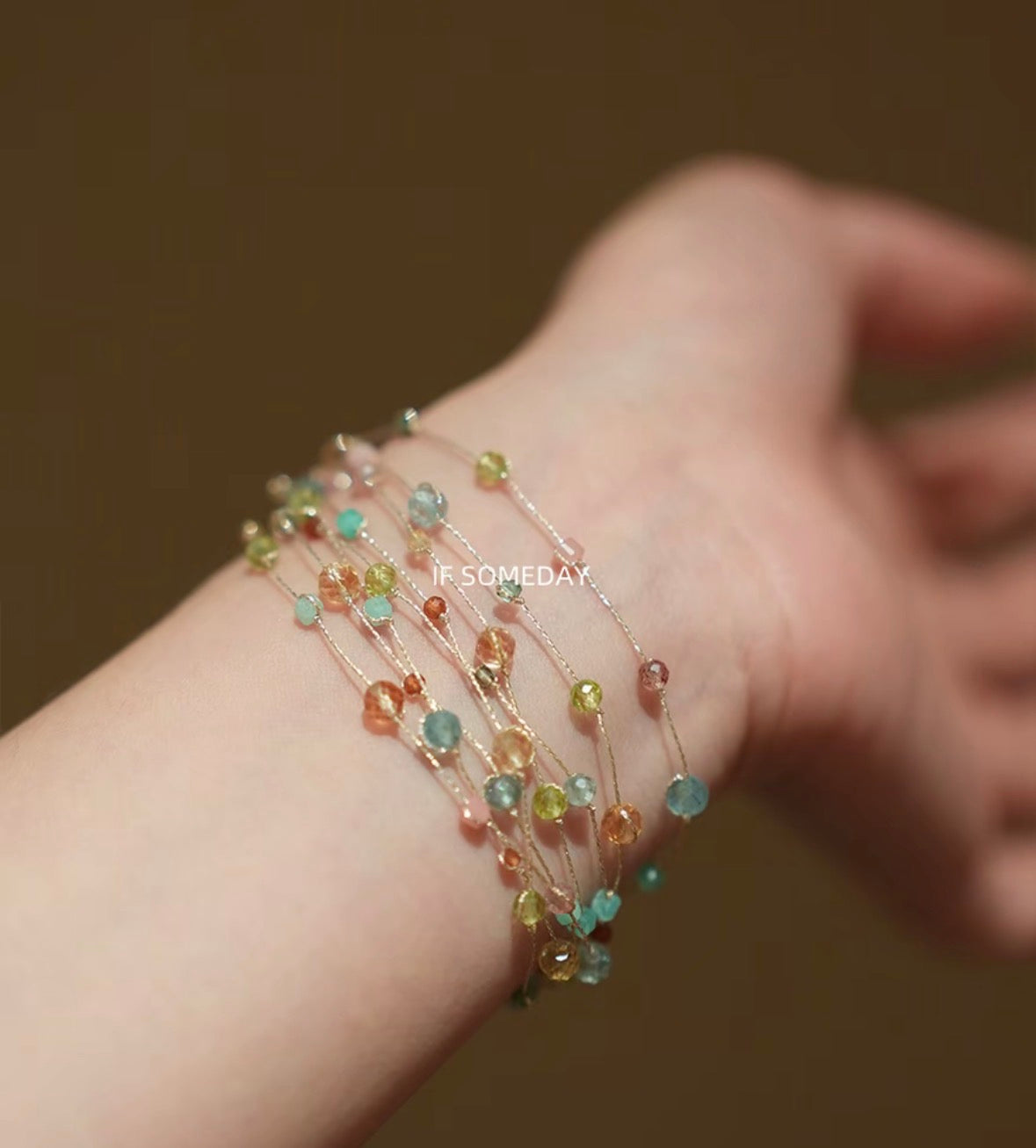 This multi-layered handmade bracelet is made of eight kinds of natural stones and features a silver clasp.