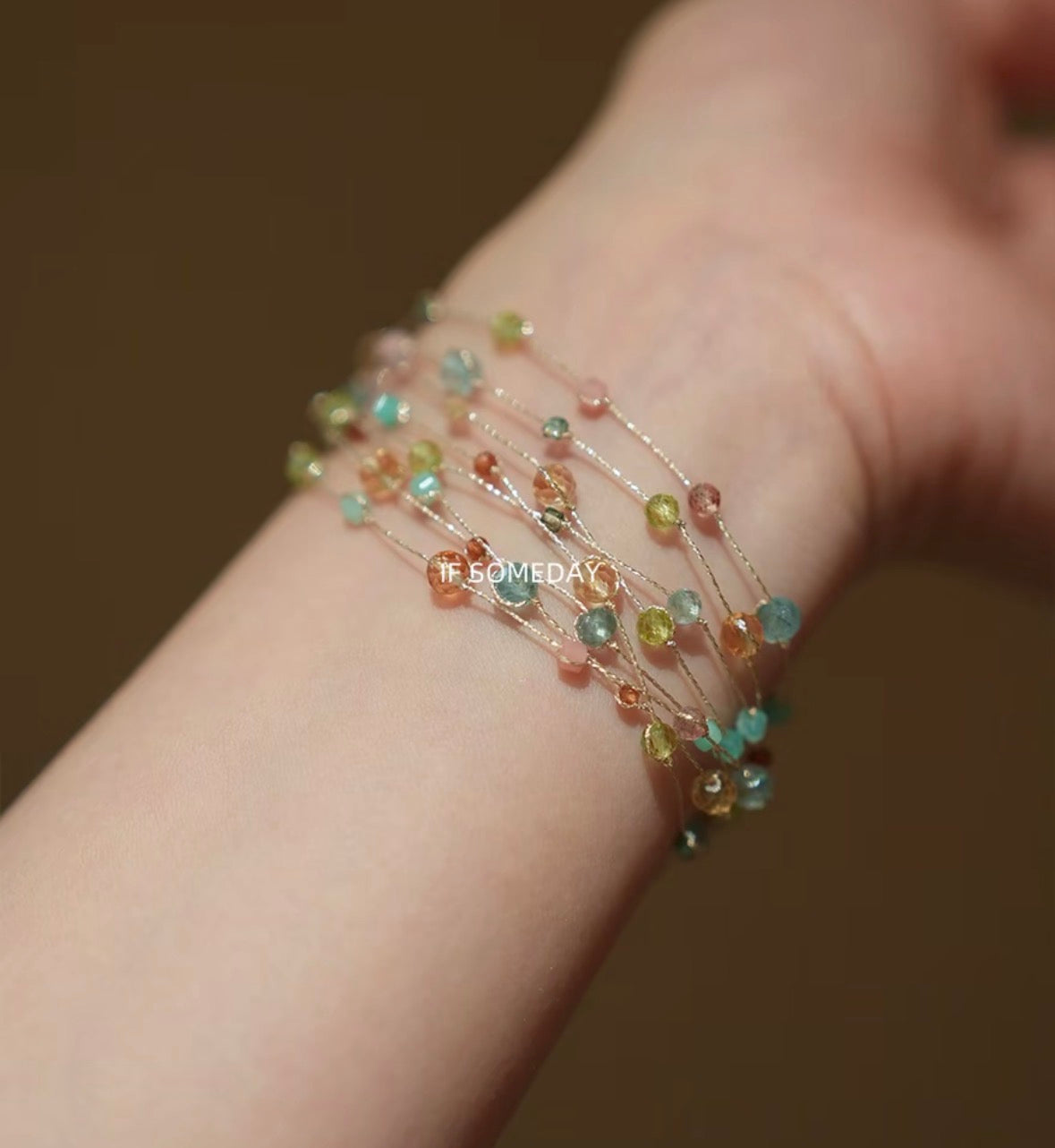 This multi-layered handmade bracelet is made of eight kinds of natural stones and features a silver clasp.
