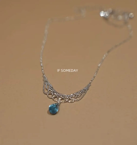 Elegant silver necklace with blue teardrop pendant, minimalist design for everyday wear